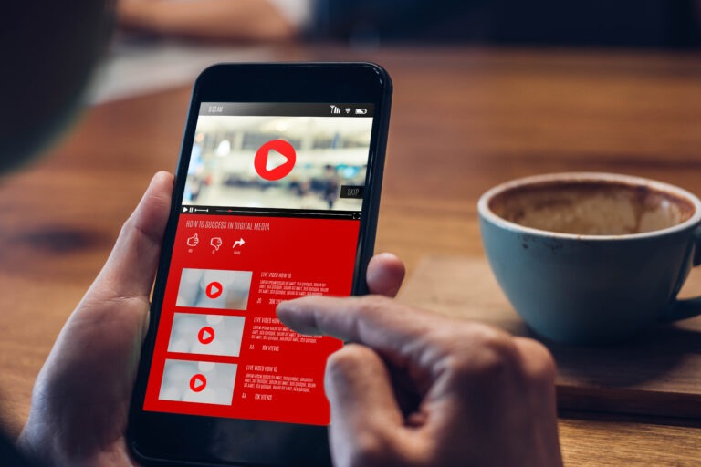 close up woman hand holding mobile watching video online with ad
