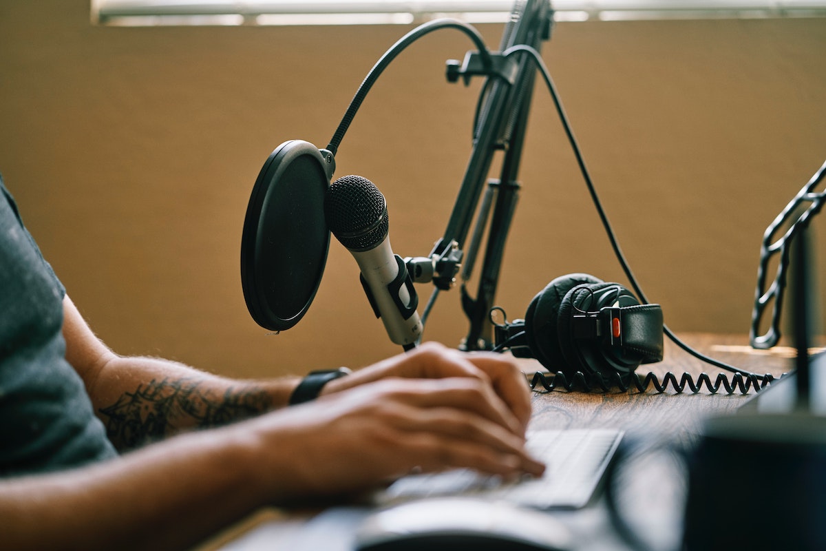 Judging a voice actor's demo: man with mic and keyboard
