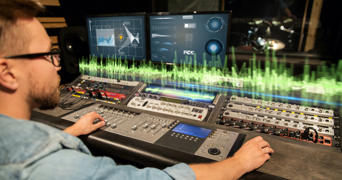 sound engineer in front of a mixer and monitors