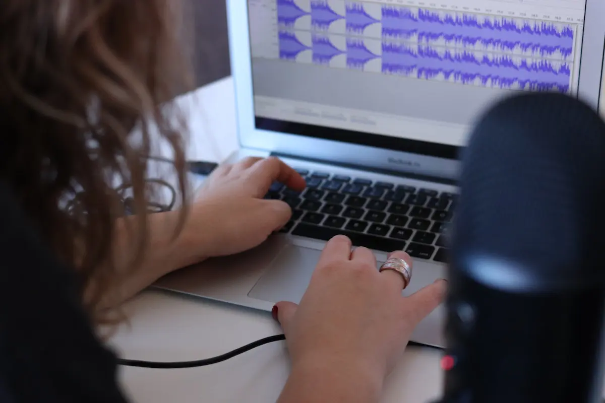 how to start a podcast: woman with laptop