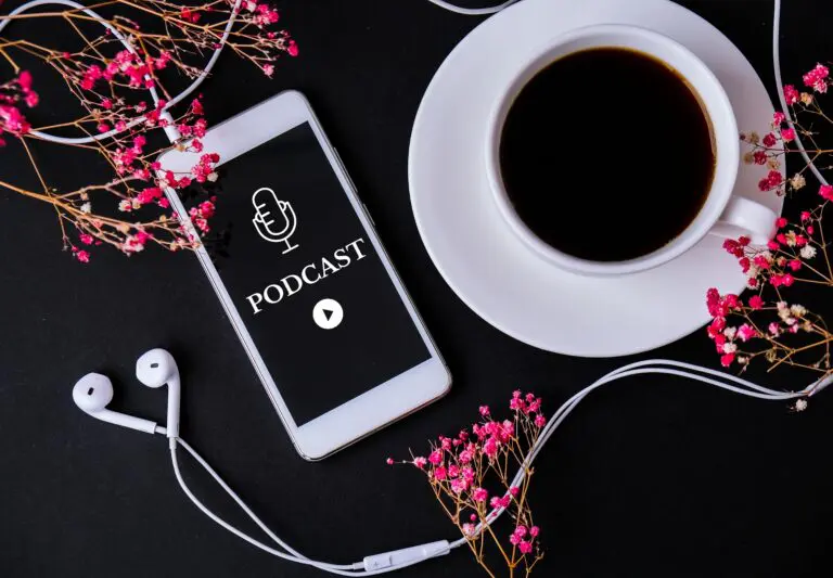 mobile-phone-podcast-with-headphones-on-workplace-2022-11-09-10-17-09-utc