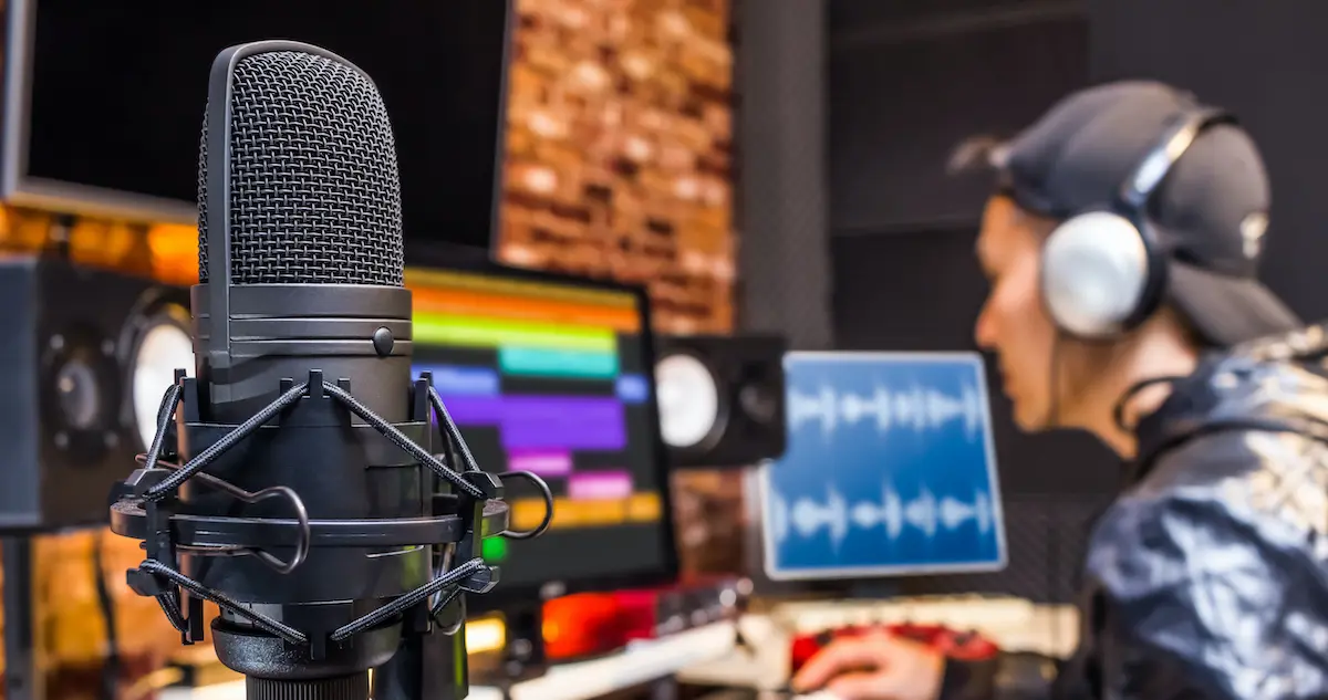 Broadcast quality voice over: sound engineer sitting a mixing desk