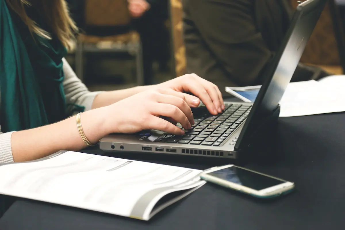 how to prepare a voice over script: woman typing on laptop

